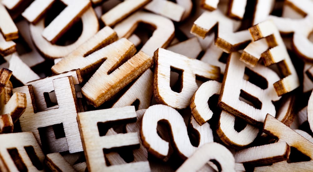 Jumbled pile of brown wooden letters