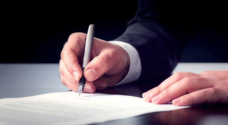 Close up of male hands signing a contract