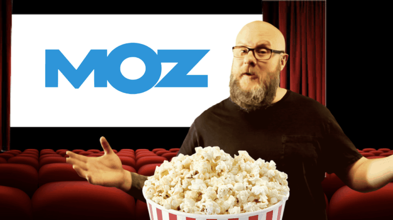 Greg Gifford of Wikimotive with a bowl of popcorn and the MozCon 2019 logo
