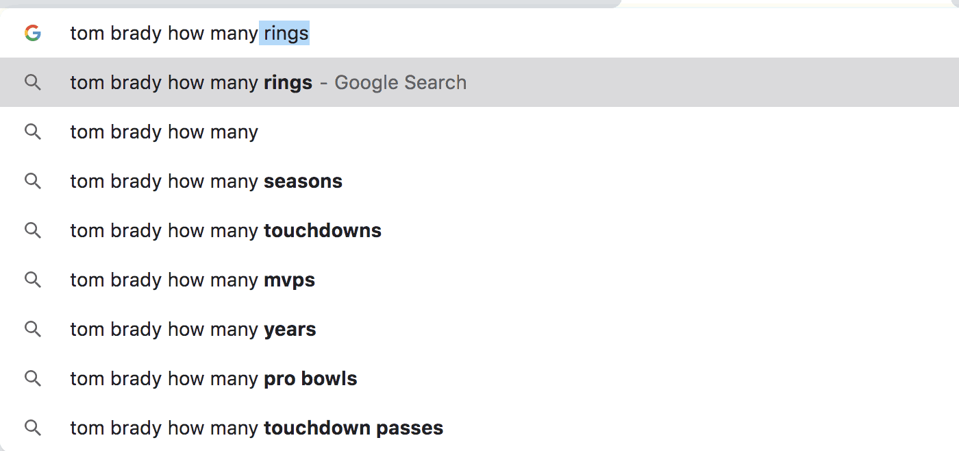 Screenshot of Google Search "Tom Brady has how many" with various autofill options
