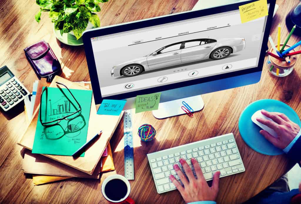 Searching for automotive marketing companies on a desktop computer on a wooden desk