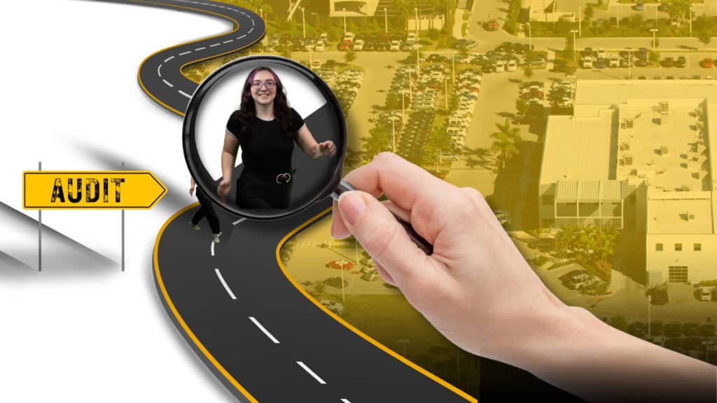 Hand hold a magnifying glass showing an automotive SEO professional above a roadmap