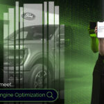 Automotive SEO professional standing holding up a smartphone next to a search bar that says Generative Engine Optimization