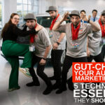 Automotive SEO professional kneeing a vendor in the gut inside of a dealership showroom.