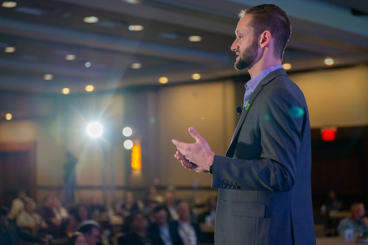 Zach Billings onstage at automotive conference